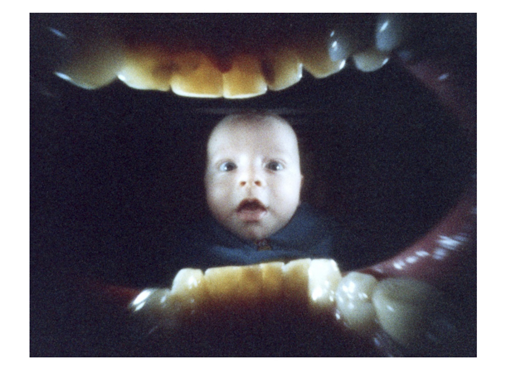 picture from inside a mouth showing teeth and a portrait of a young baby