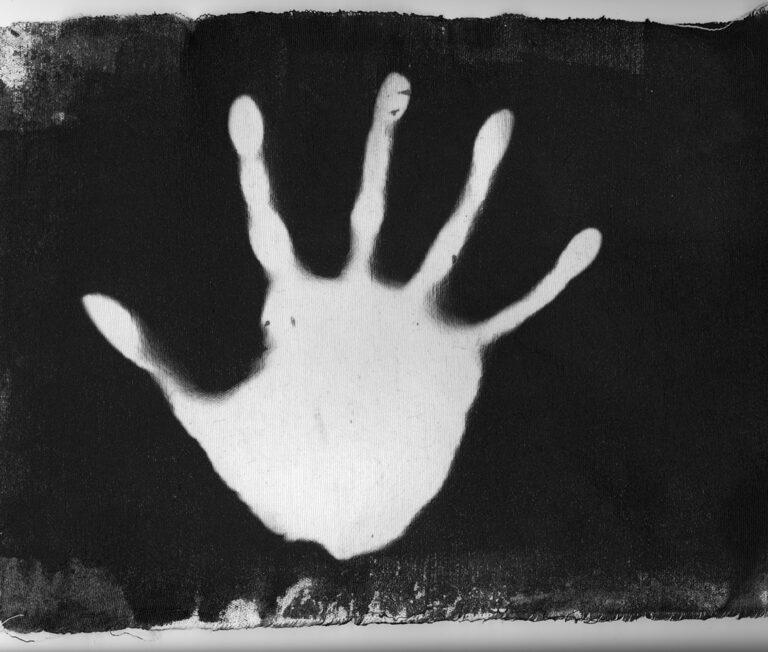 A high contrast picture of a hand, printed on fabric